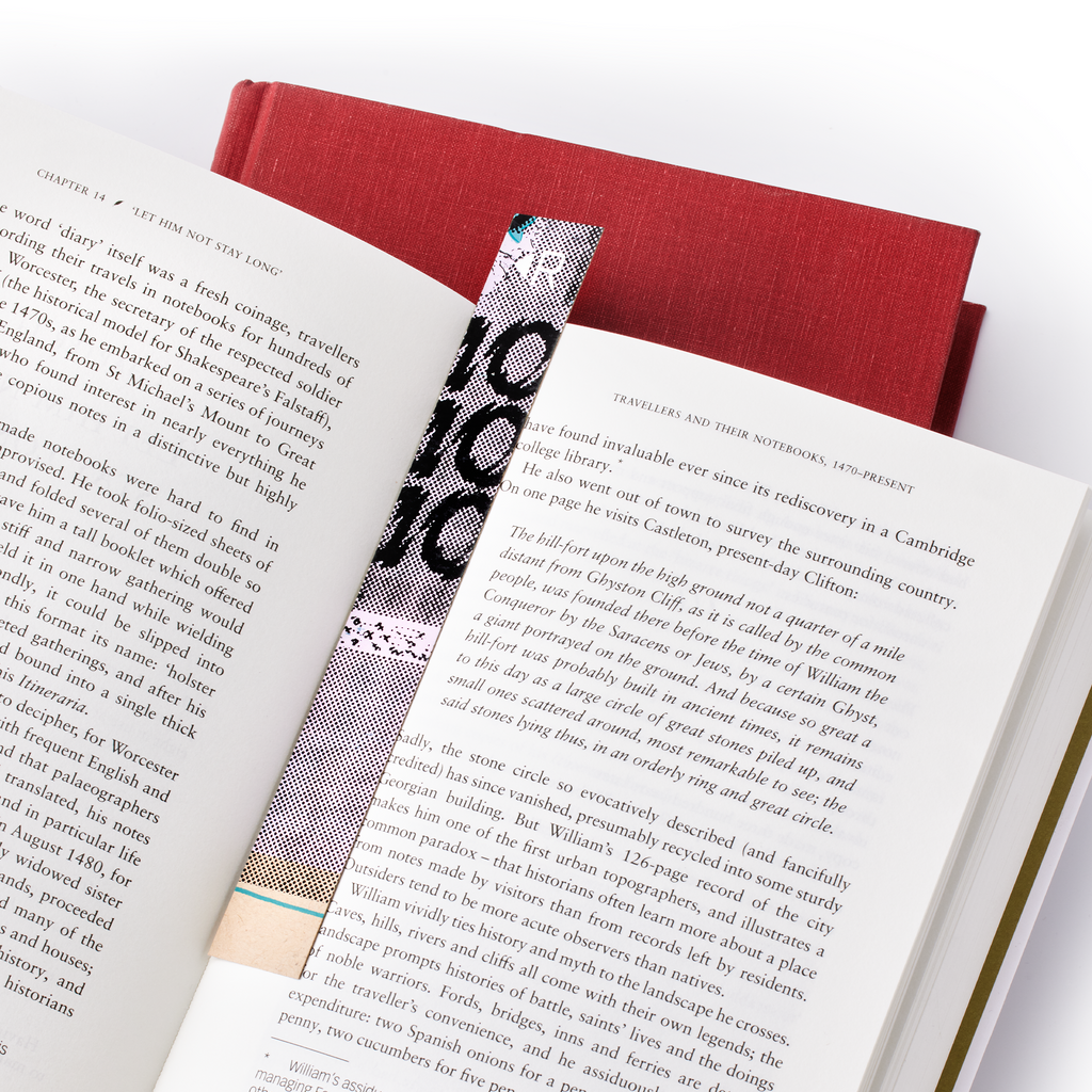 Resketch Bookmark made from 100% Reclaimed and rescued paper marking an open page in a book.
